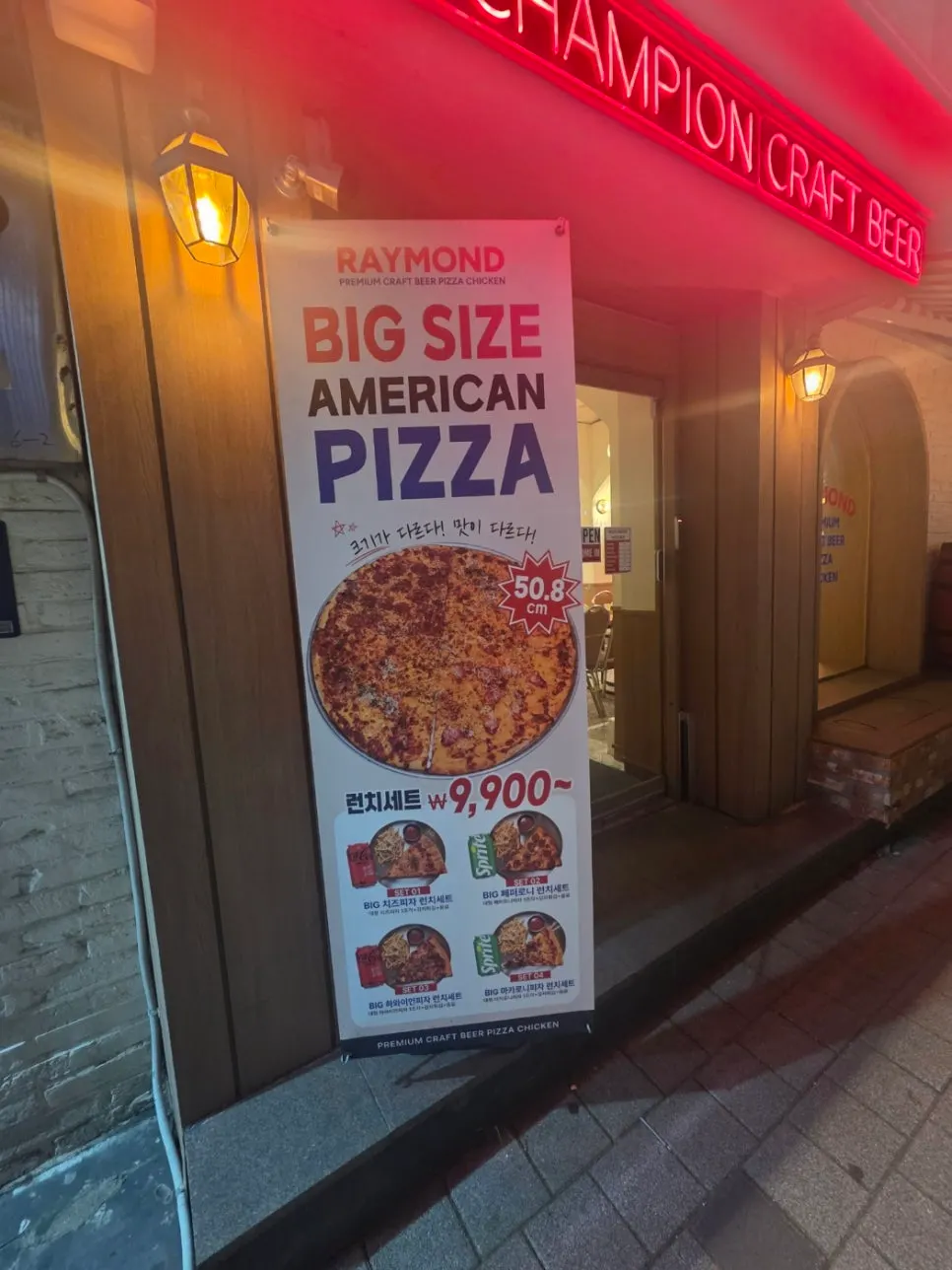 American big-size pizza standing sign at the entrance of Raymond Isu Branch
