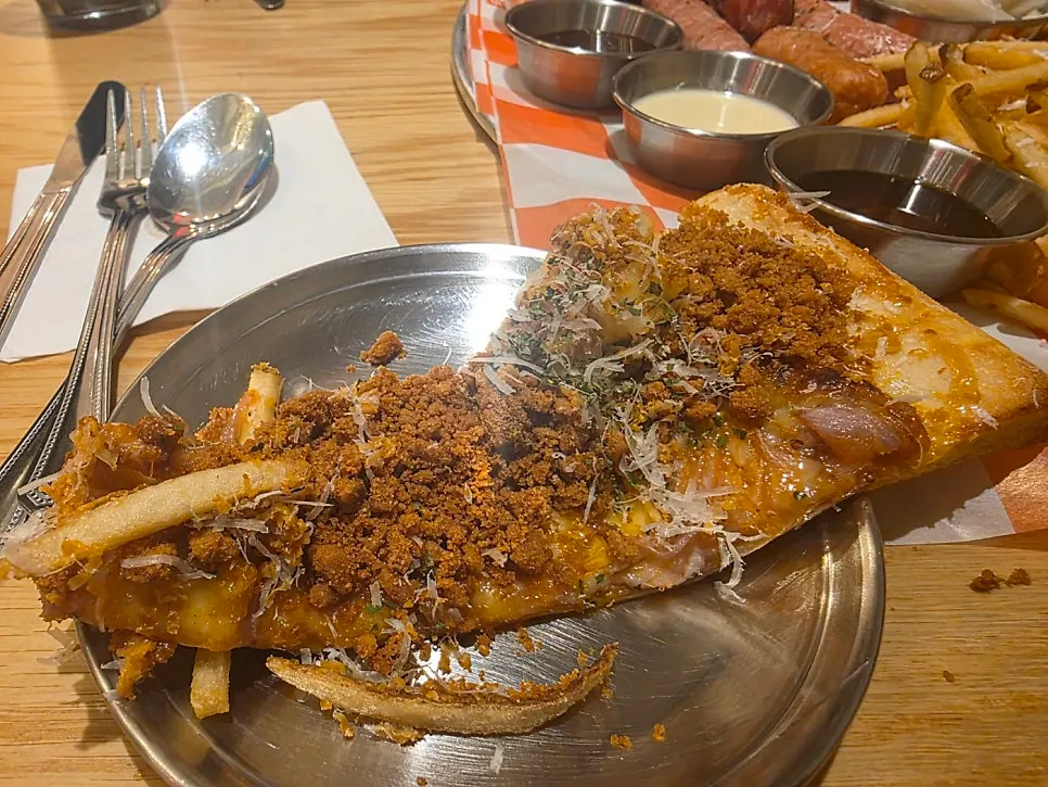 Pizza slice placed alongside 4 sauces