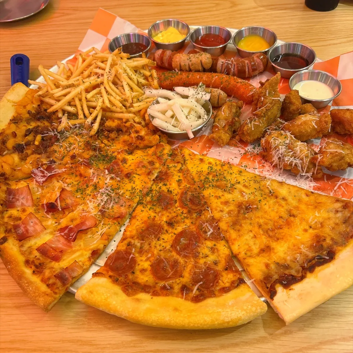Table spread of Raymond Set pizzas and sides