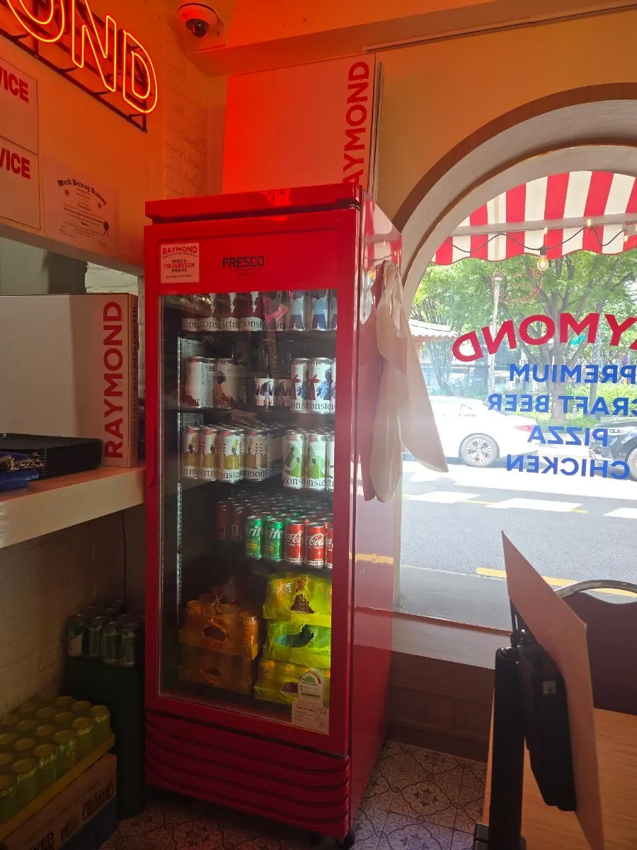 Beer fridge with aprons hanging nearby