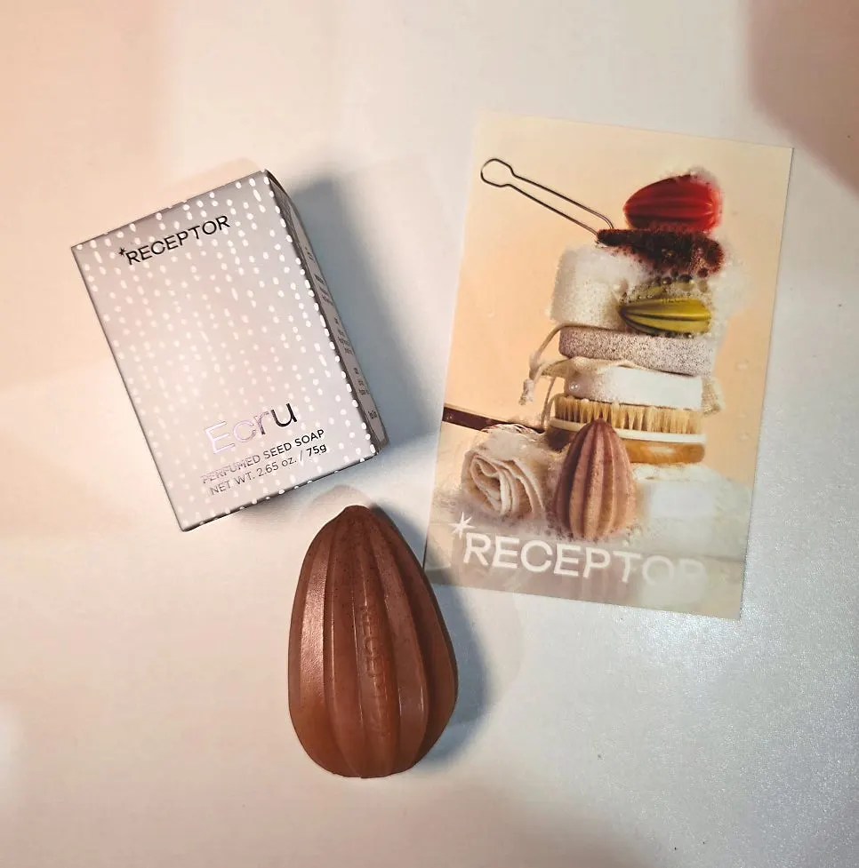 The curved shape of the seed-shaped soap held in hand