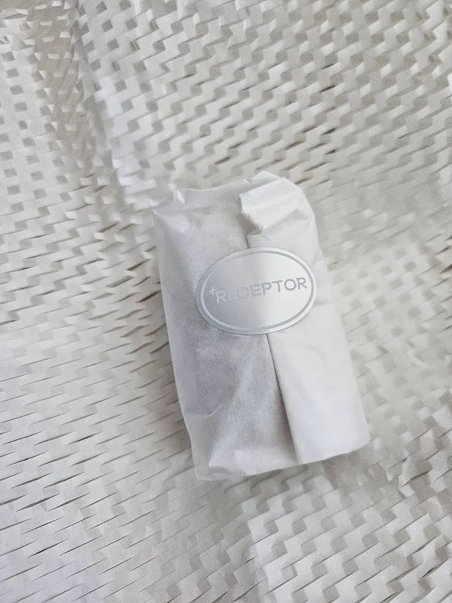 Seed-shaped perfume soap resting in a hand