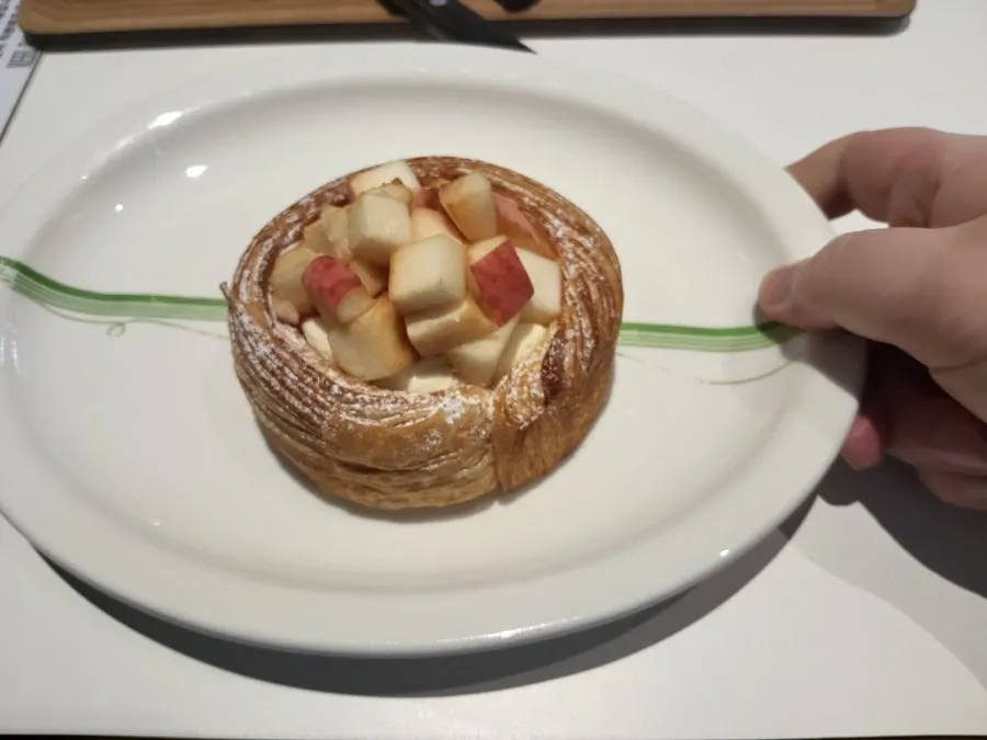 Fruit cream pastry sliced open with a knife