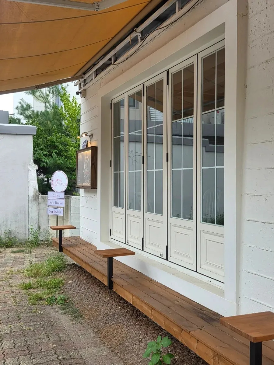 White two-story standalone house exterior of Respire Bakery Cafe Seochon