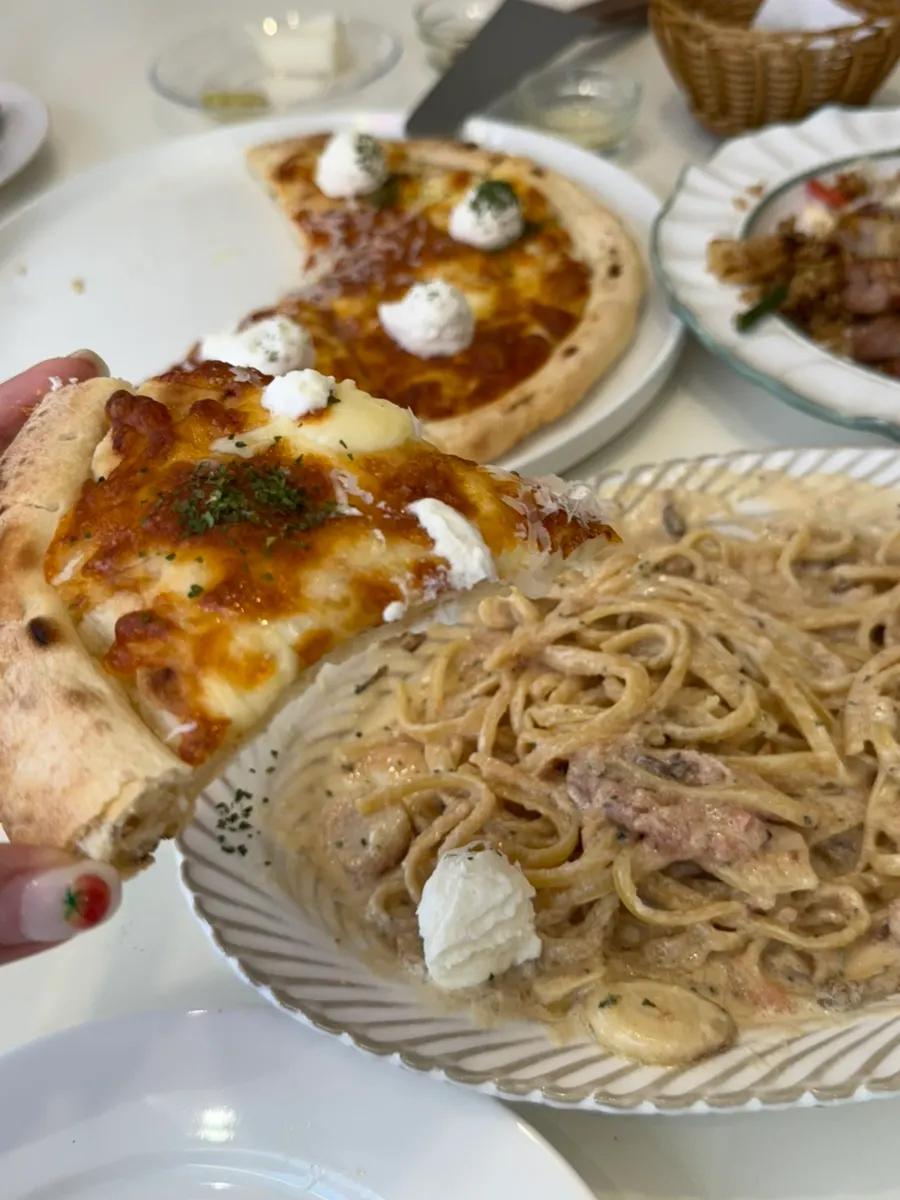 A slice of the thin-crust quattro formaggi pizza