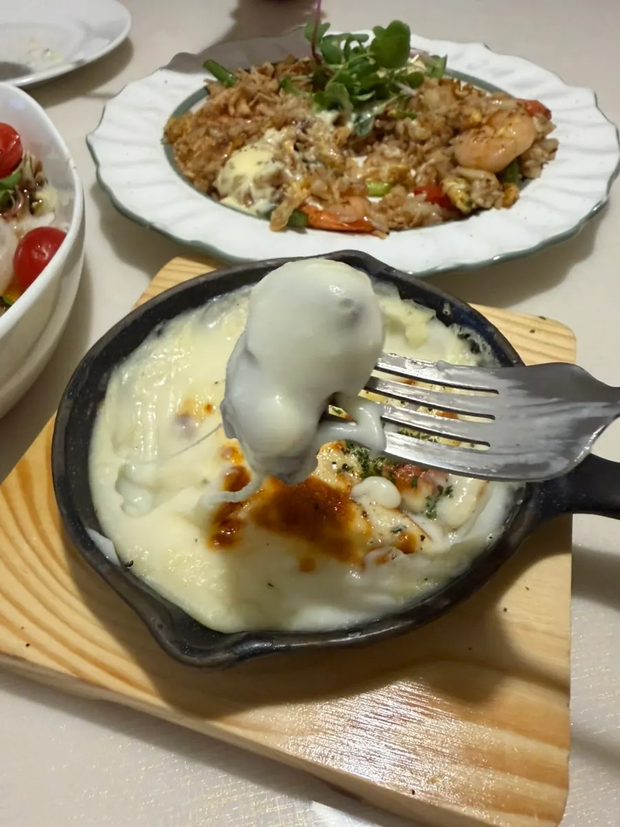 Spoonful of cheesy potato gratin