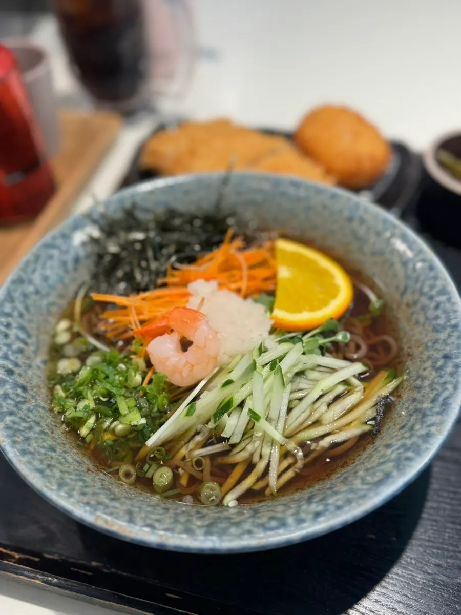 Cold soba topped with a slice of orange