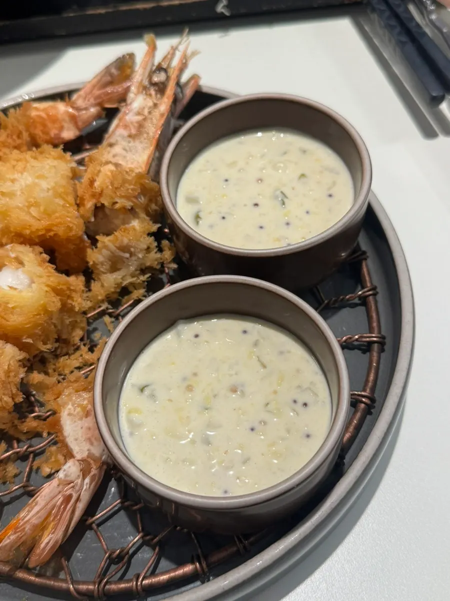 Cross-section of the shrimp fry dipped in tartar sauce