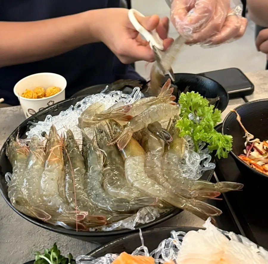 A full spread of live shrimp sashimi and assorted sashimi