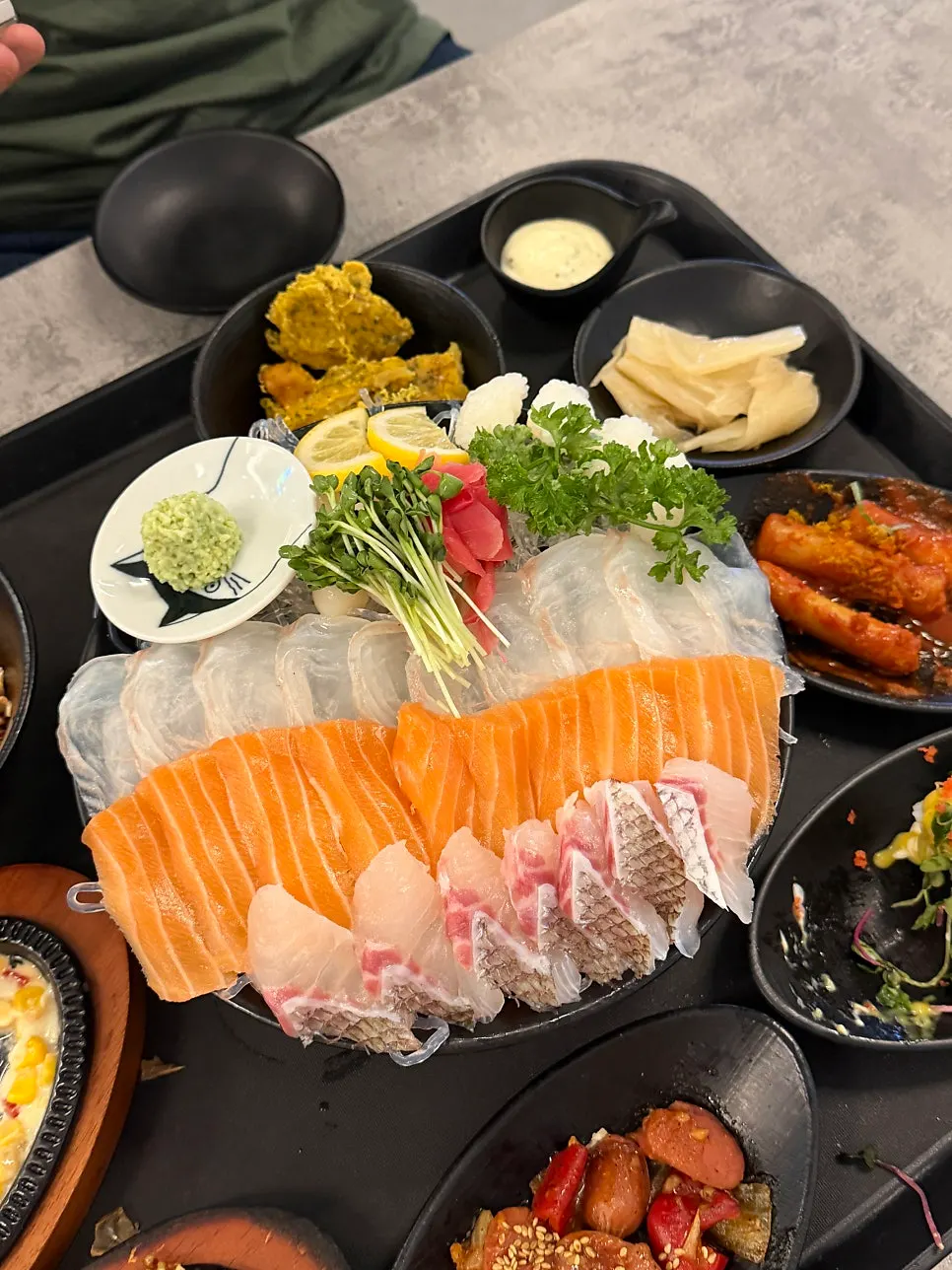 Close-up of aged sashimi platter with flatfish, red seabream, and salmon