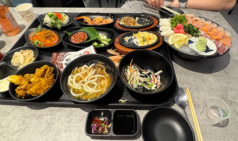 Full spread with the sashimi combo and all side dishes laid out