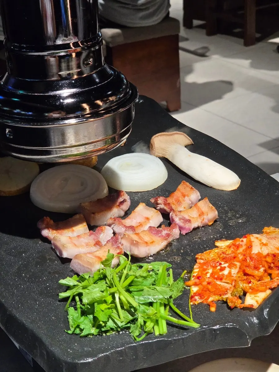 Risan's pork belly grilling on the pan