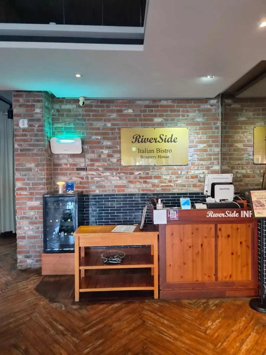 Interior of the restaurant with wood tones and brick