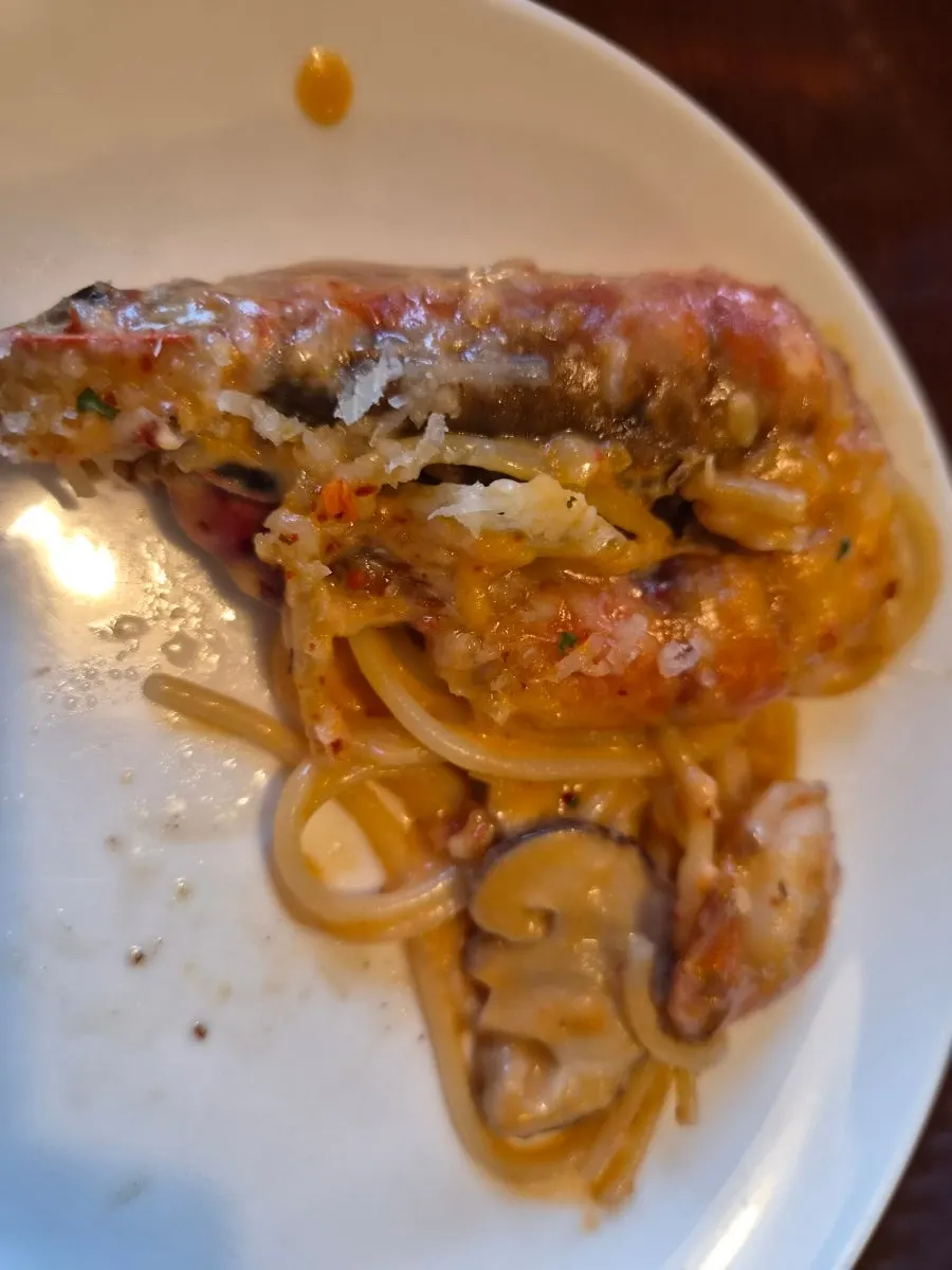 Rosé pasta topped with big shrimp