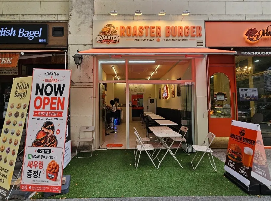Roaster Burger's storefront next to a bagel shop