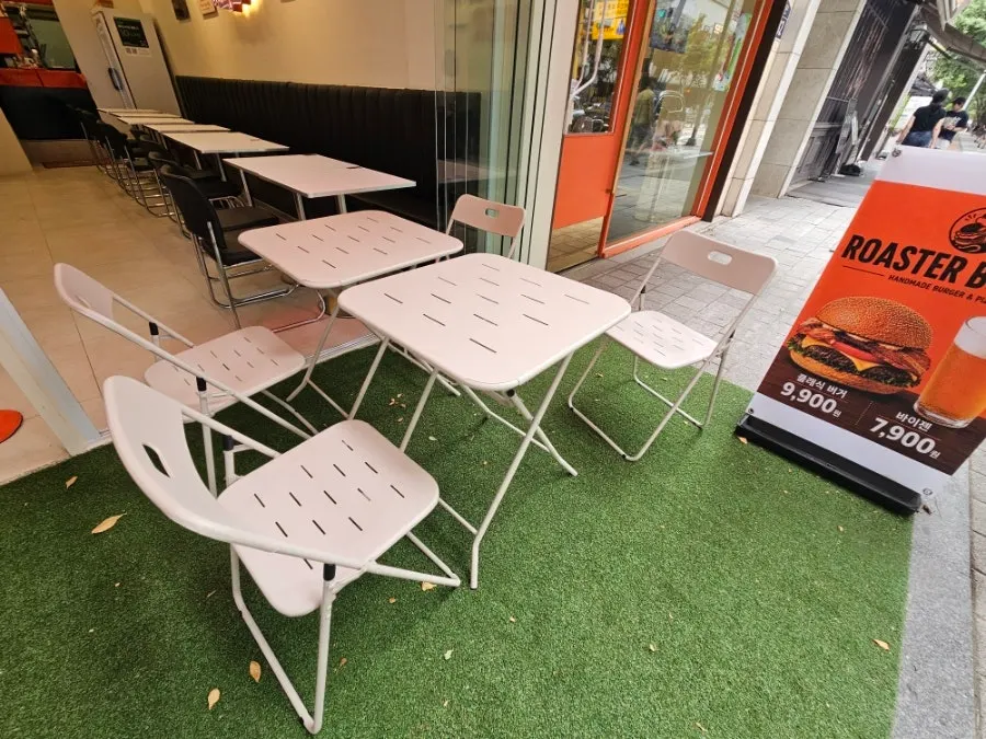 Outdoor table seating at Roaster Burger
