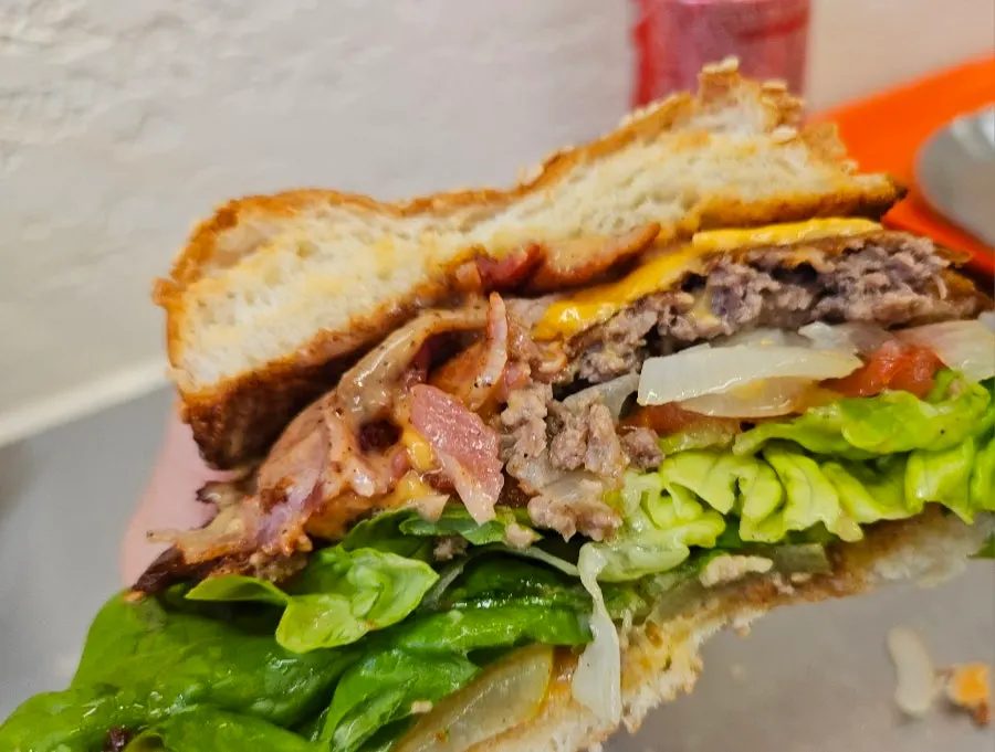 Cross-section of the classic burger cut in half, showing the smash patty