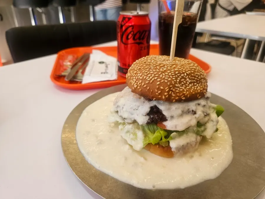 The white burger served alongside sides