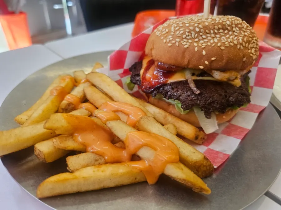 A plate with the spicy whole shrimp beef burger