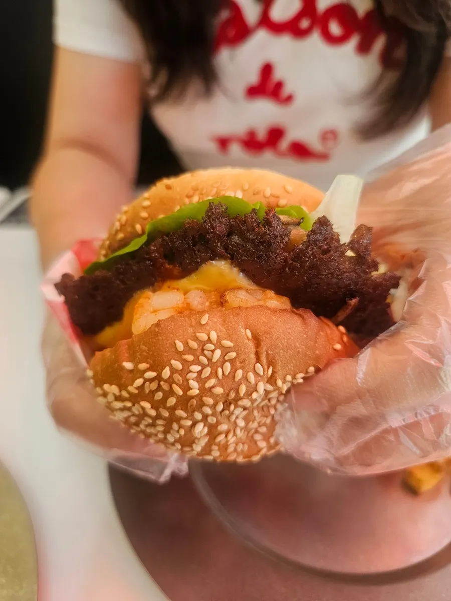 Cross-section of the burger with beef patty and whole shrimp