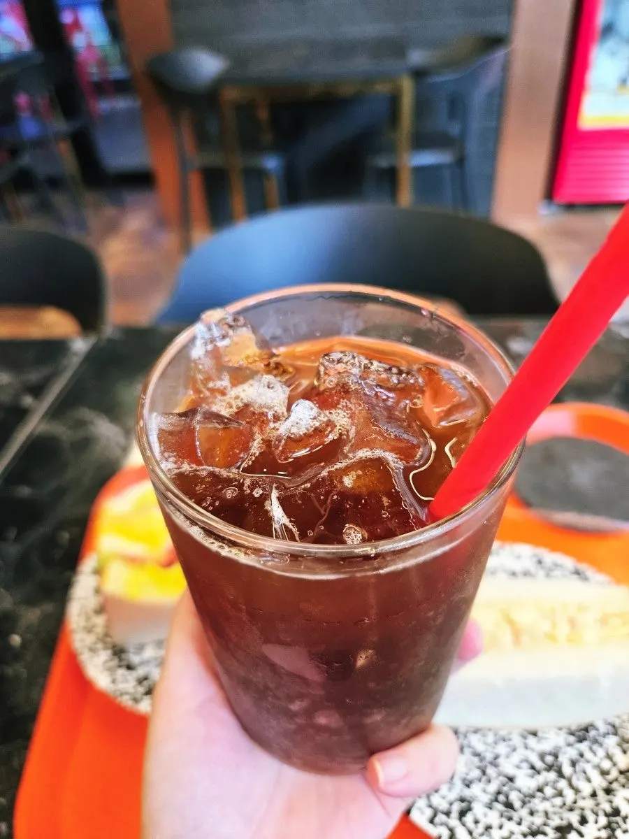 Iced americano served with a bean explanation