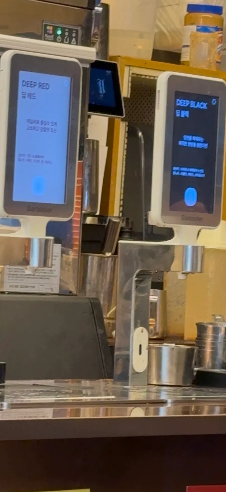 Drink posters and menu near the register