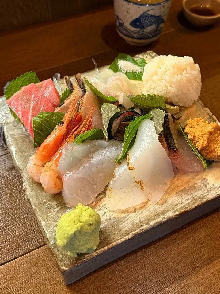 Plate of aged sashimi including flounder, sea bream, and Spanish mackerel
