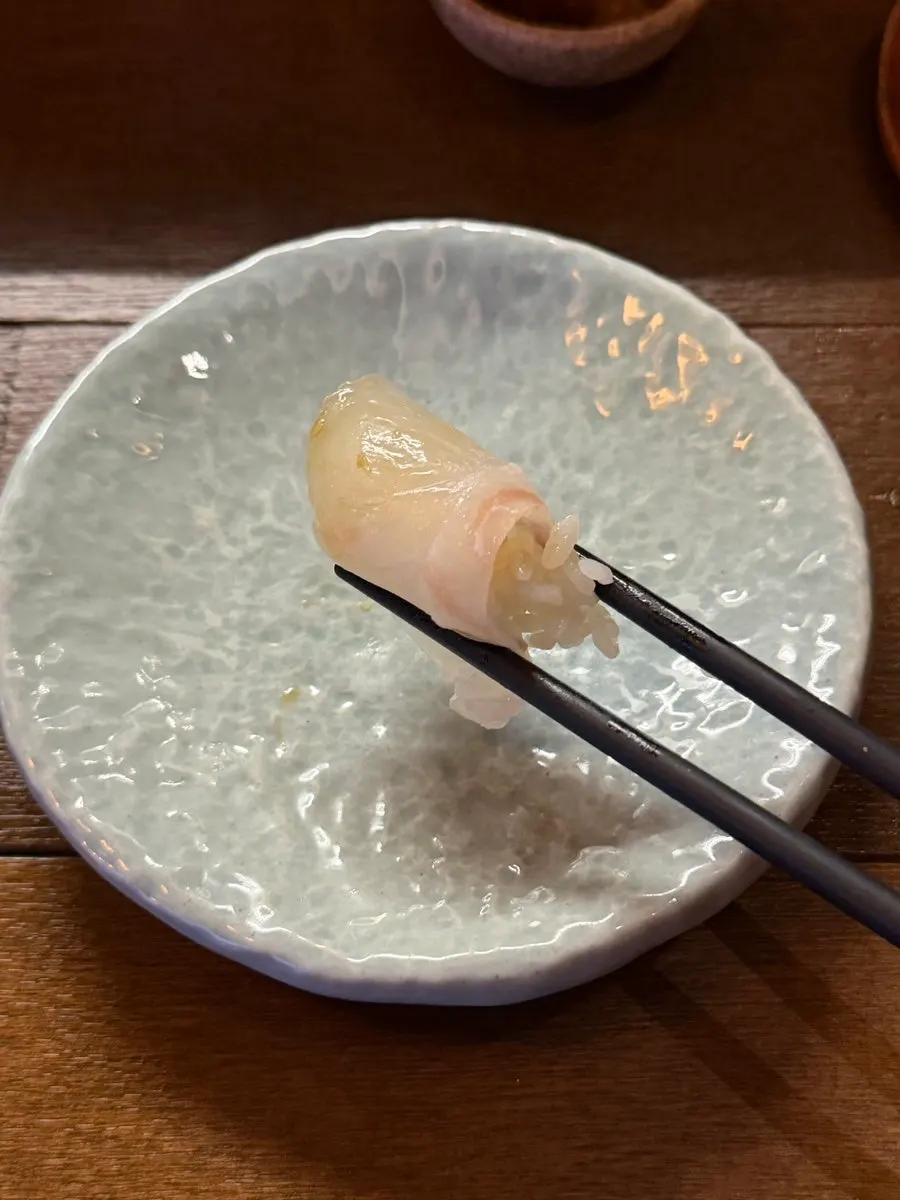 A piece of flounder placed on vinegared rice
