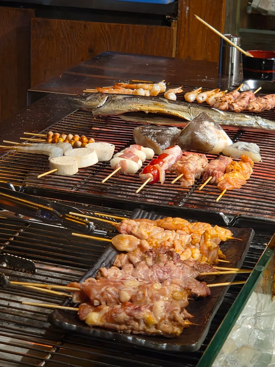 Skewers and ingredients displayed in front of the counter seats