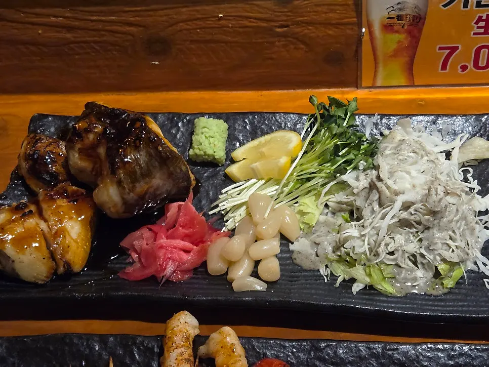 A plate of grilled sea bass with side accompaniments