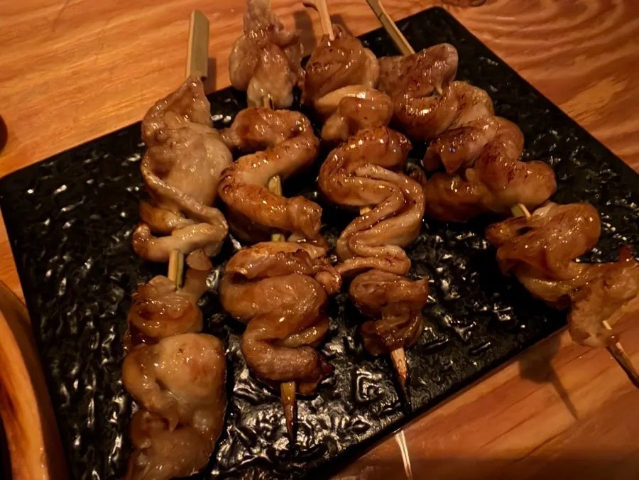 Close-up of chicken skin skewer on a plate