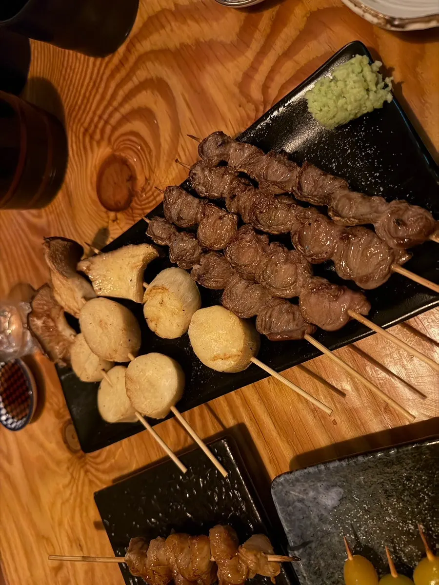 Plate of mushroom skewer and chicken heart skewer
