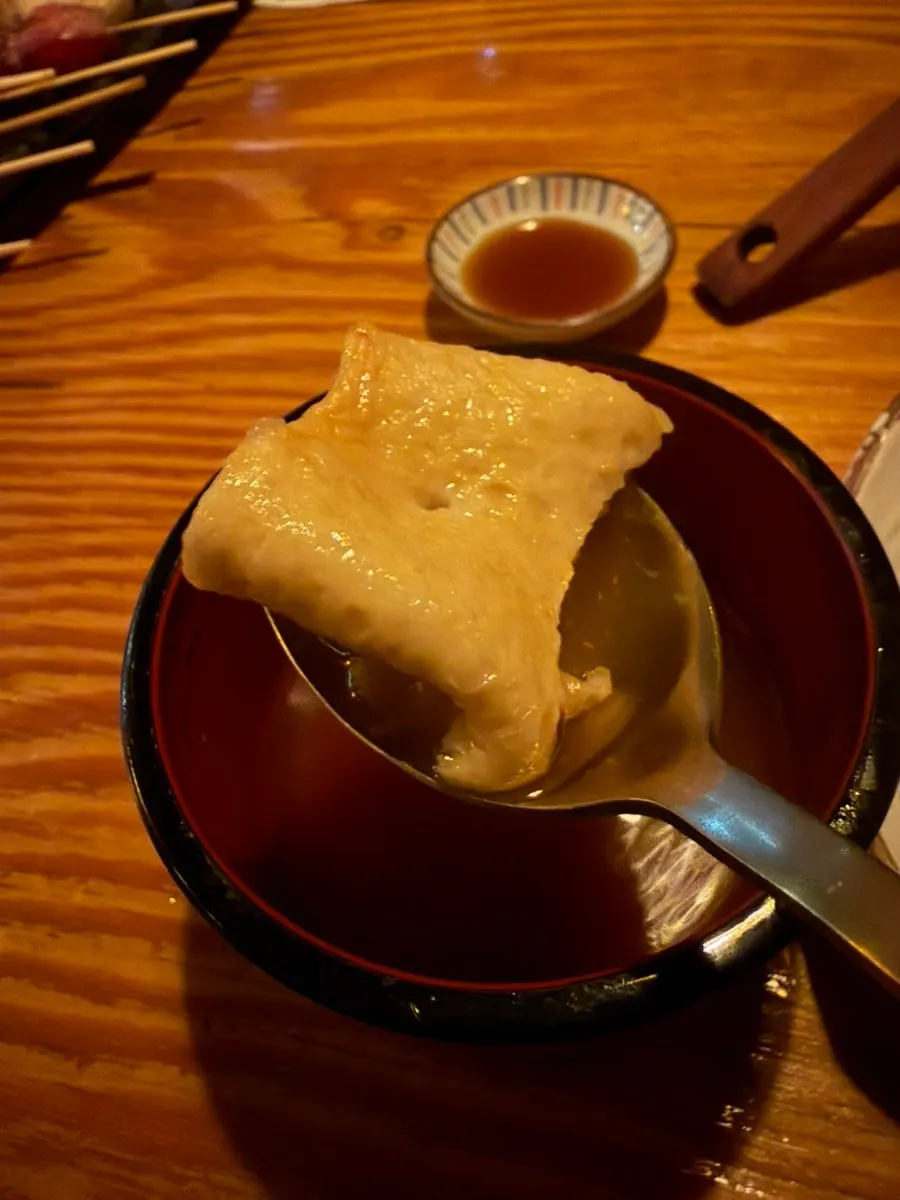 A scoop of oden nabe broth