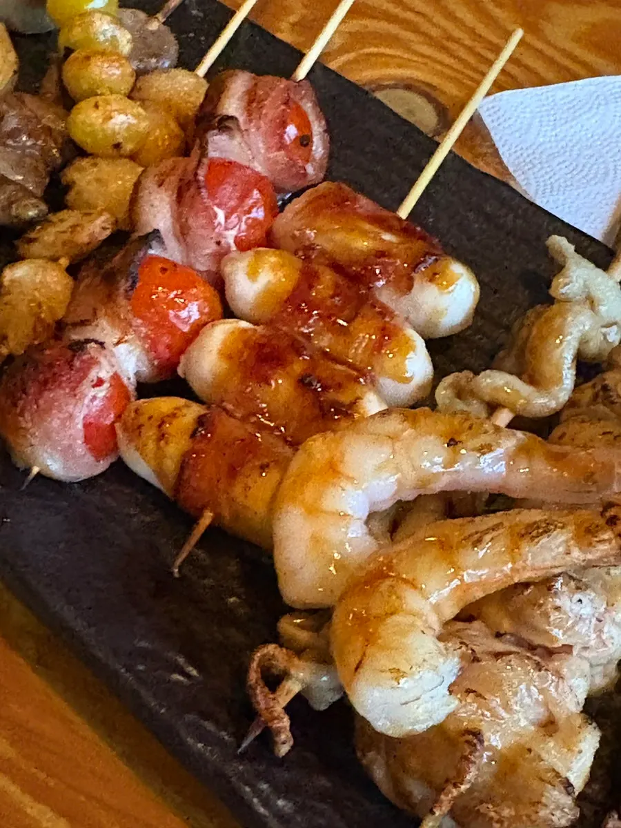 Cheese rice cake and tomato bacon skewers
