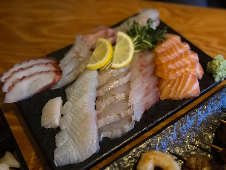 Sashimi and skewer platter together on the table