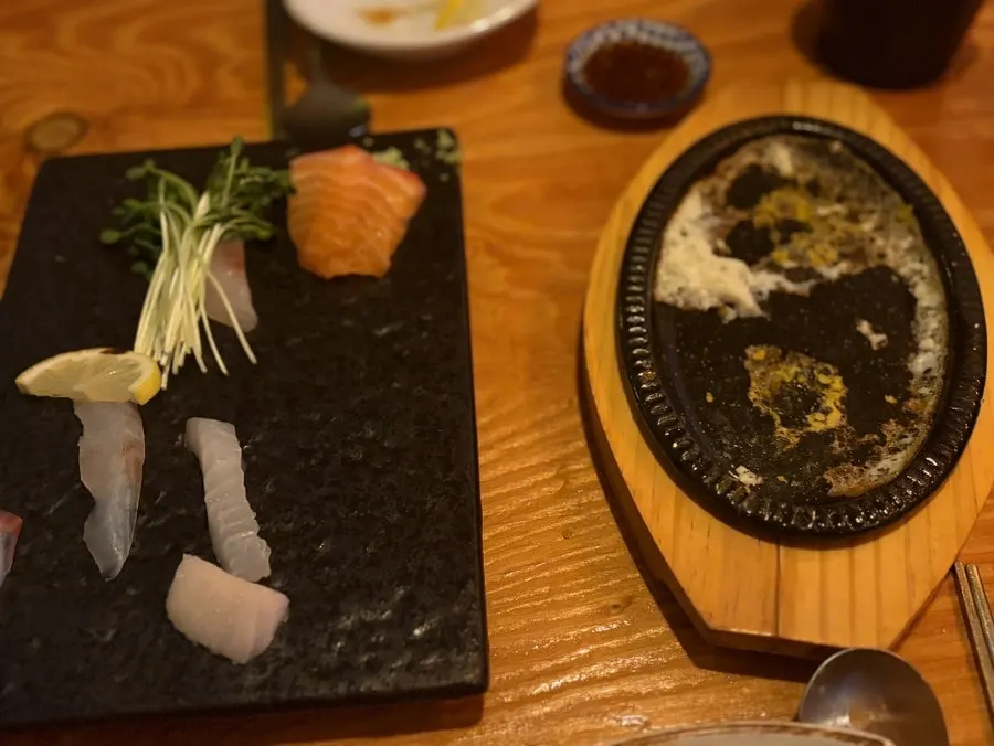 Empty plates of sashimi and skewers after finishing