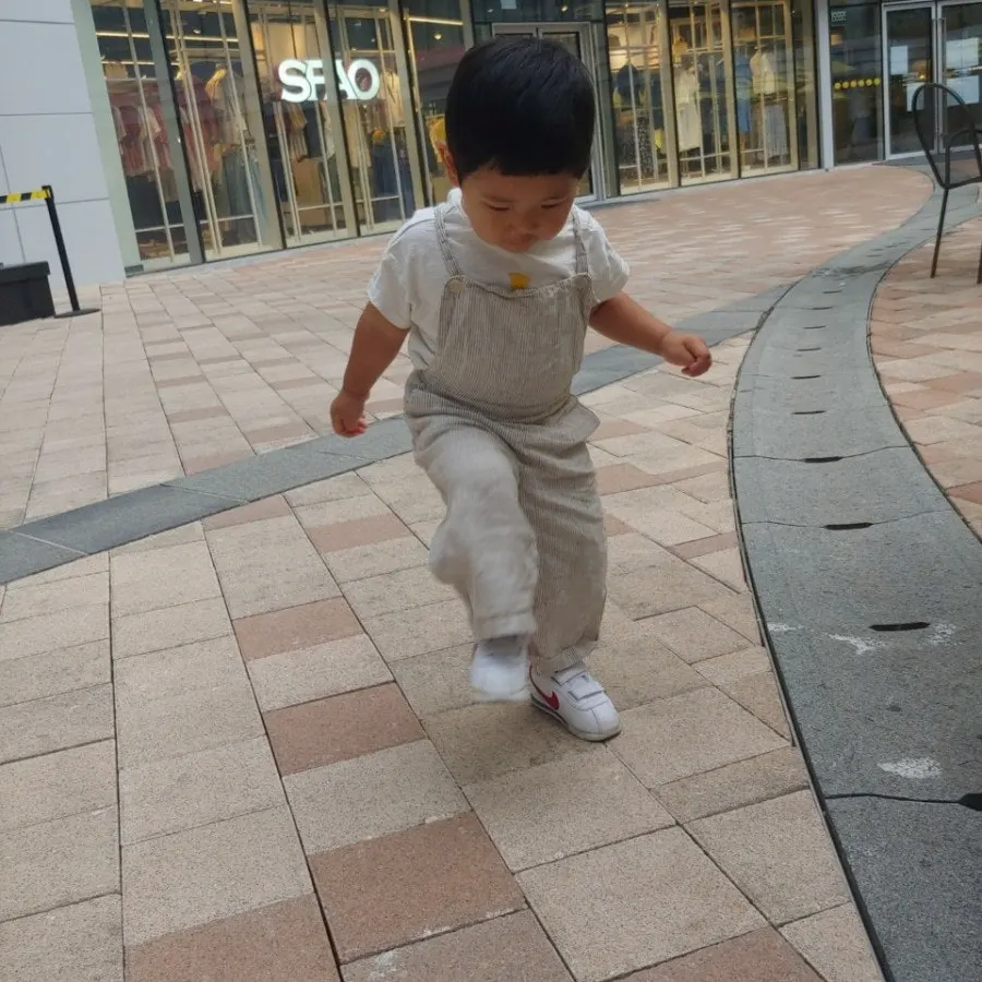 Baby overalls worn in a roomy summer fit