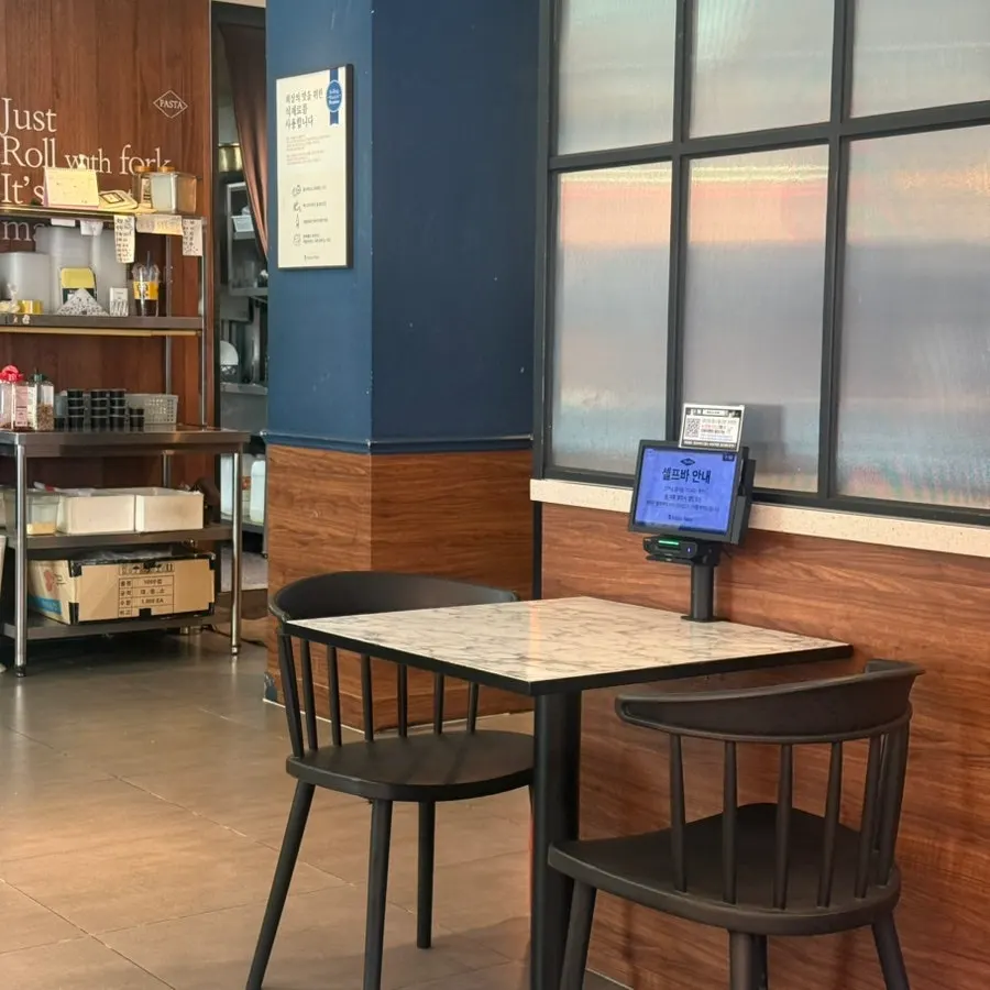Interior with two-seat tables occupied by solo diners