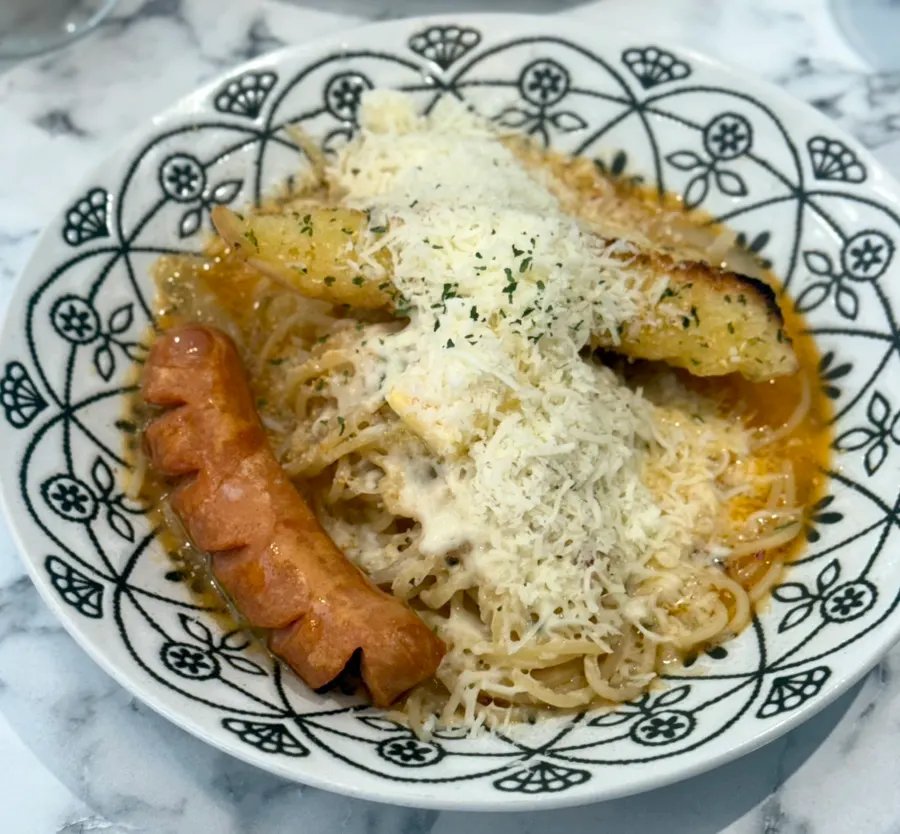 A plate of butter garlic pasta topped with butter