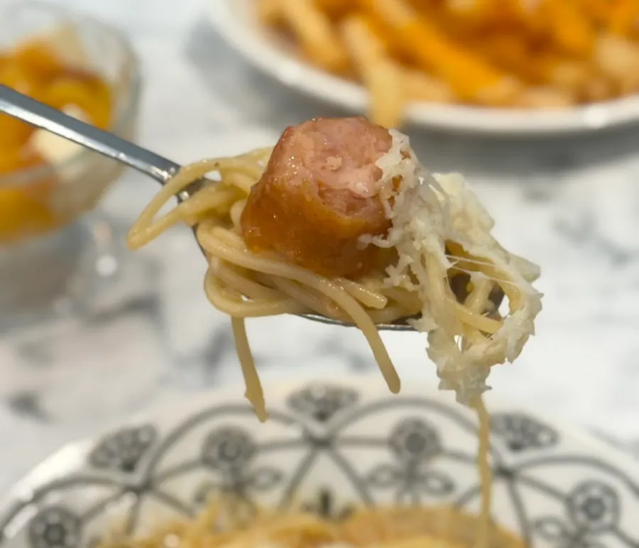 Sausage and cheese added on top of the pasta