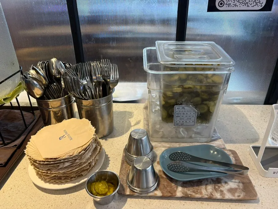 The self-bar with cutlery, pickles, and water