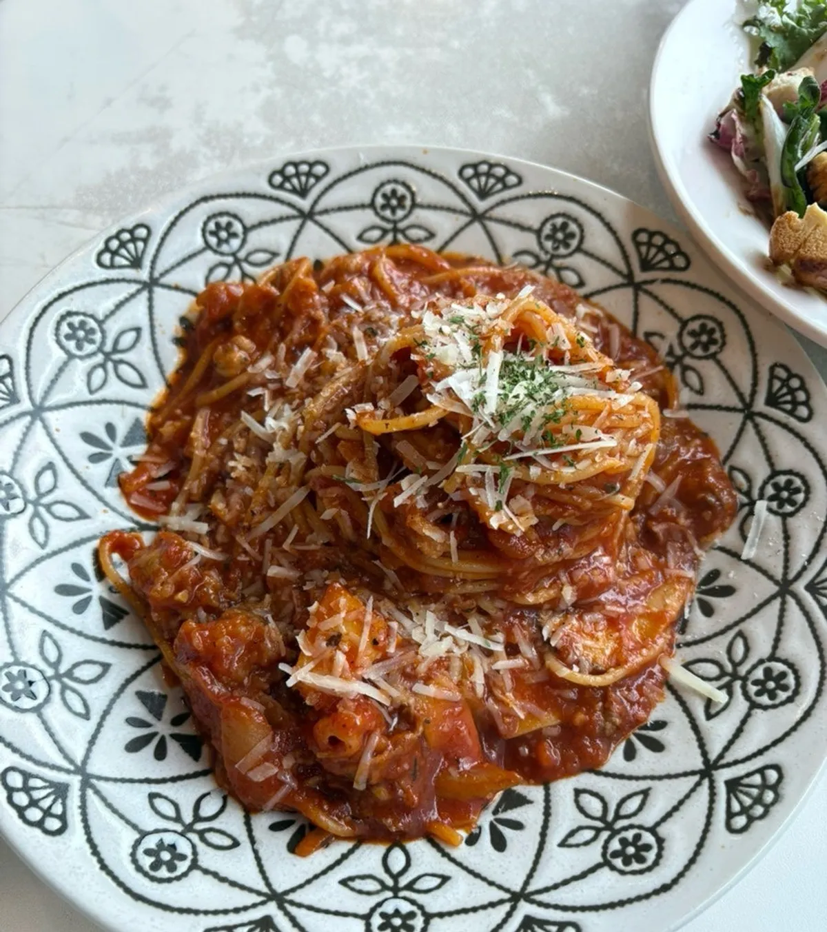 Close-up of the spicy tomato pasta topped with beef brisket