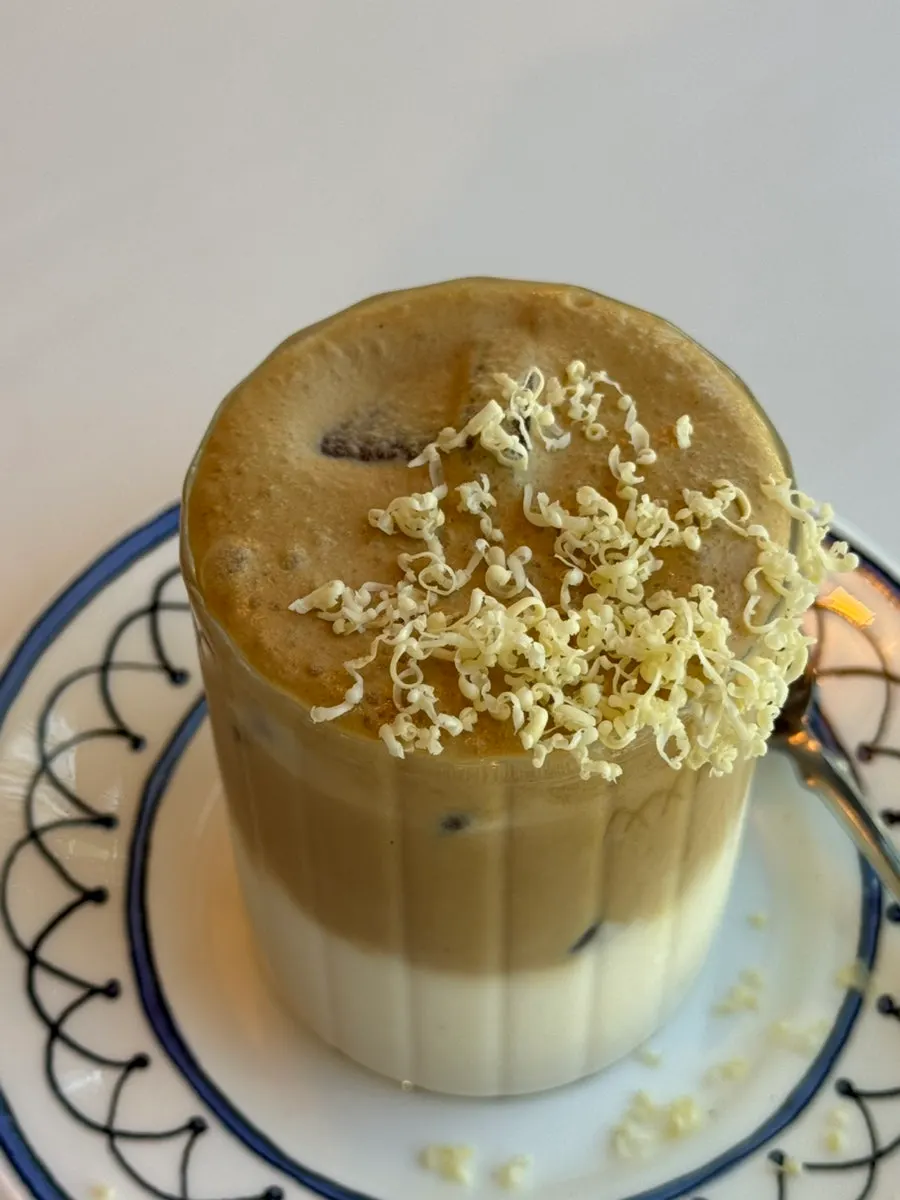 Butter Bouquet Café Latte topped with cream