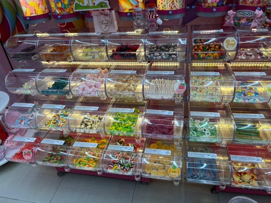 Large cylinders filled with colorful candy along the upper wall
