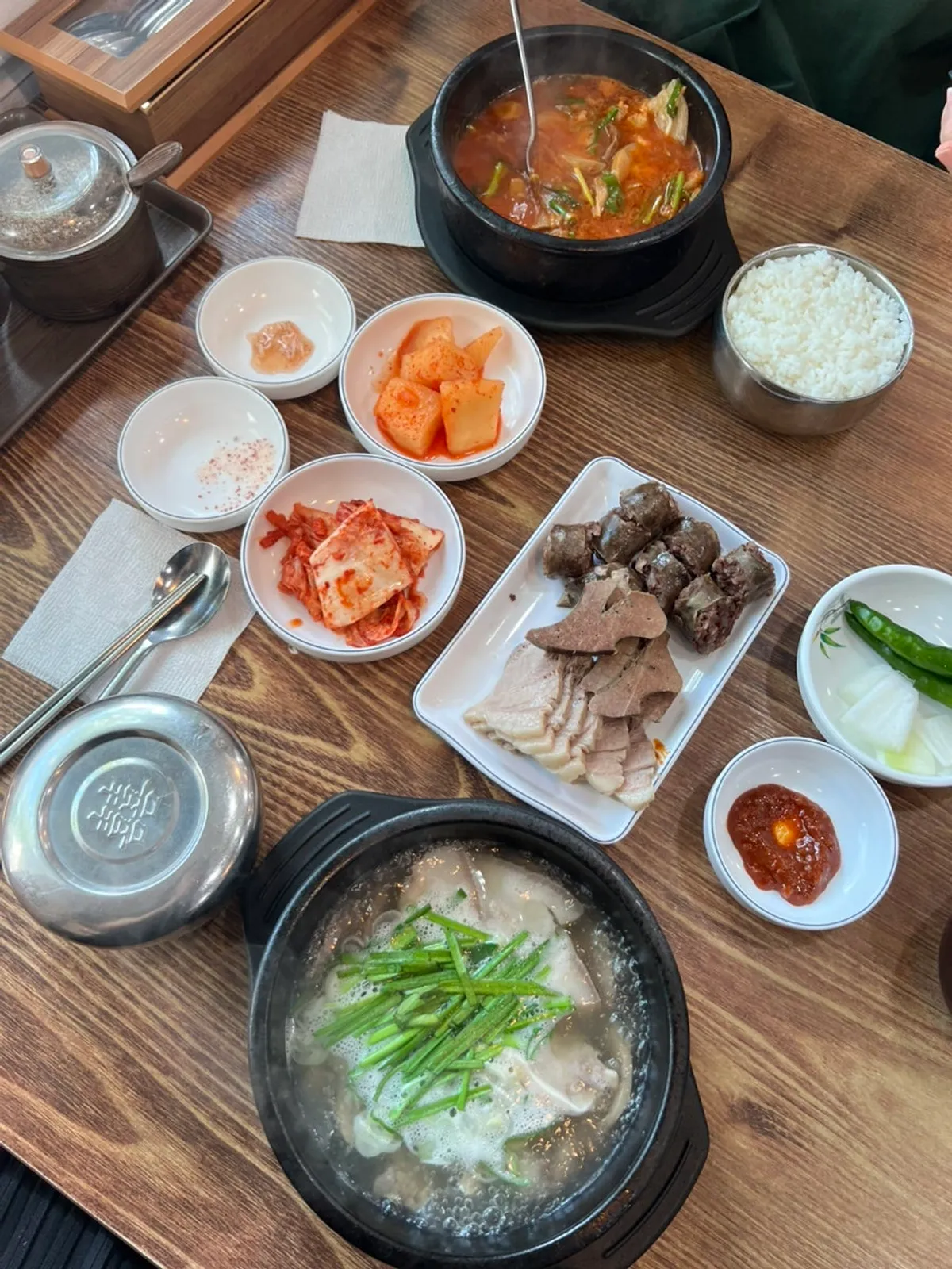 Roman Gukbap set meal and Spicy Pork Soup set meal laid out