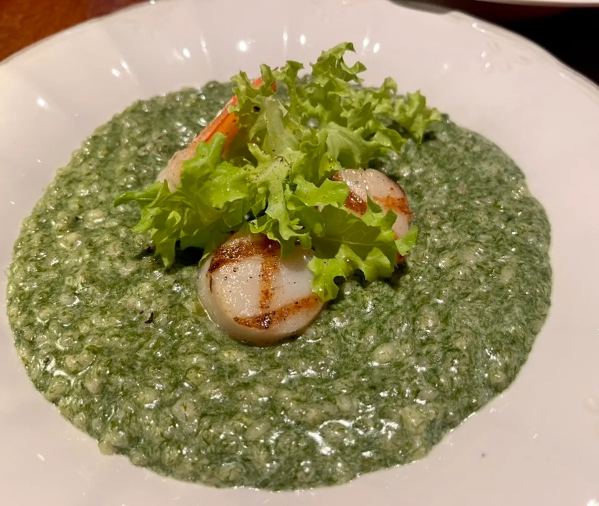 A plate of green sea mustard scallop risotto