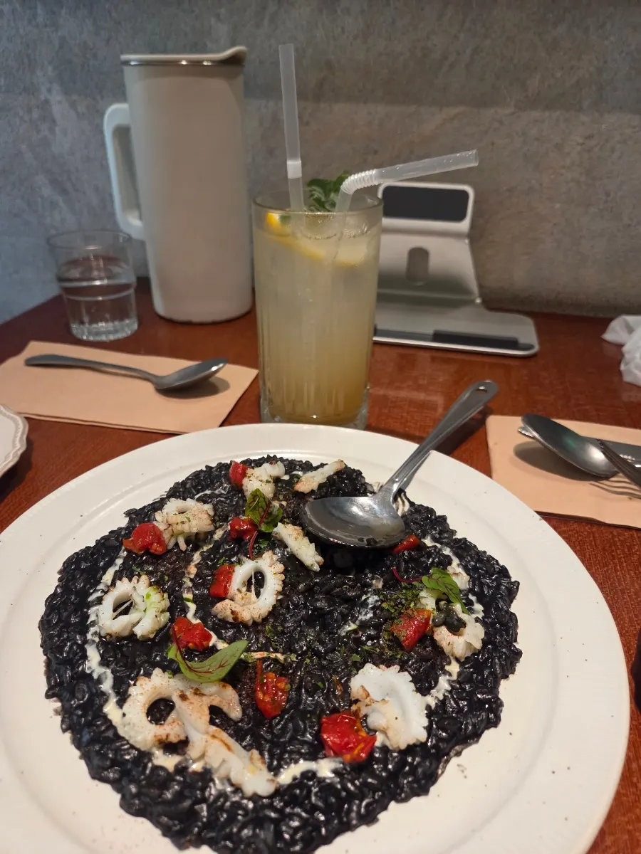 A spoonful of ink risotto lifted up