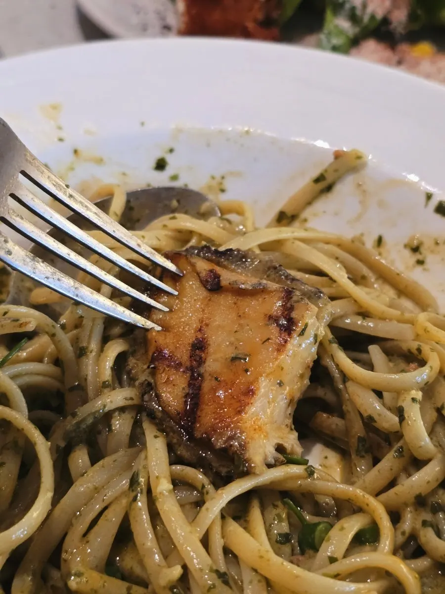 A bite of geou pasta topped with kelp-steamed abalone