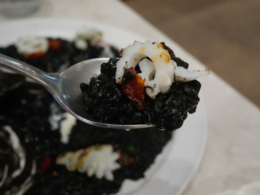Eclipse squid ink risotto topped with grilled cuttlefish