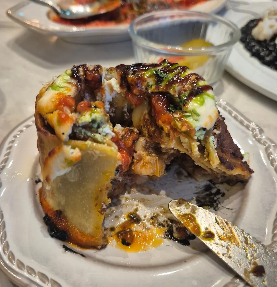 Beef ragu fresh-pasta lazagna roll served with sauce